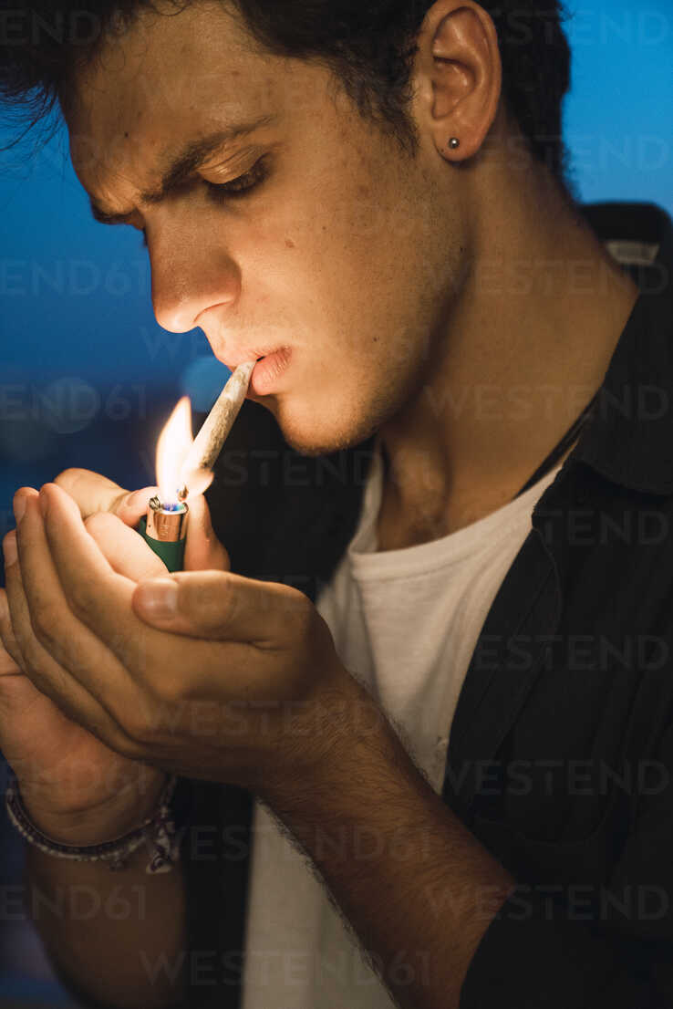 young man smoking a joint